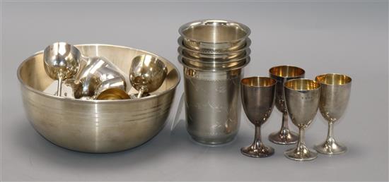 A set of four sterling silver engraved beakers, two sets of six miniature silver goblets and an Indian presentation bowl